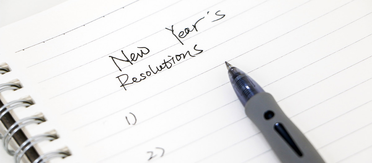 New Year's resolutions written in notebook with pen