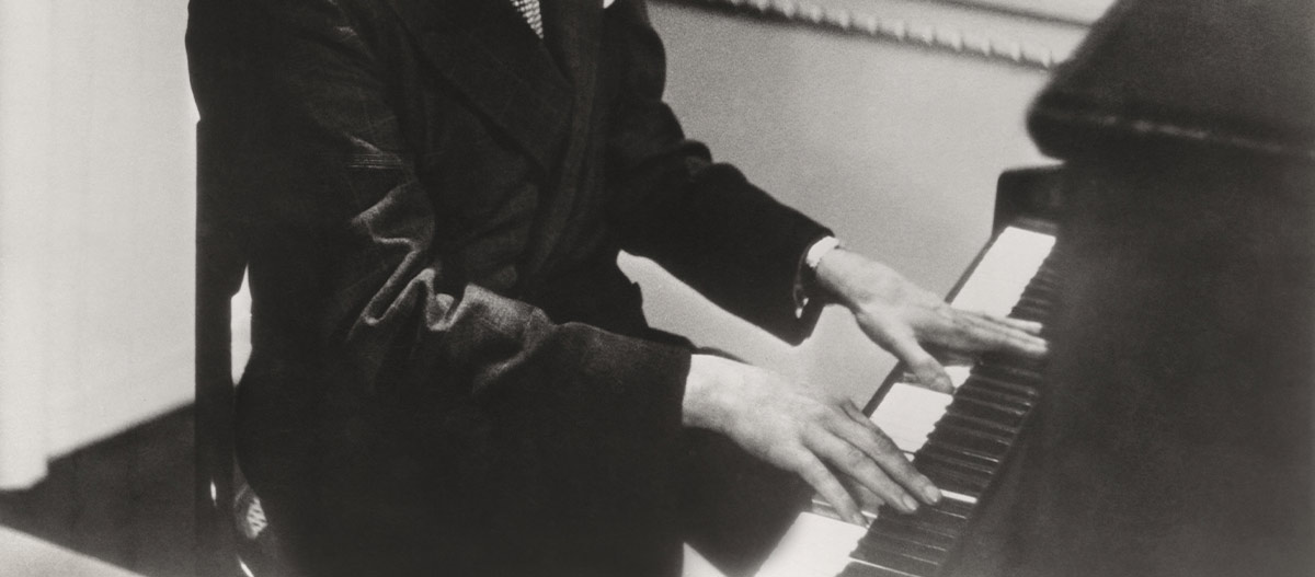 Old photo of hands on piano keyboard