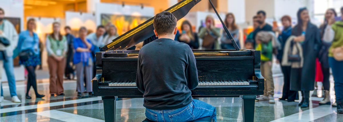 Pianist covered with people