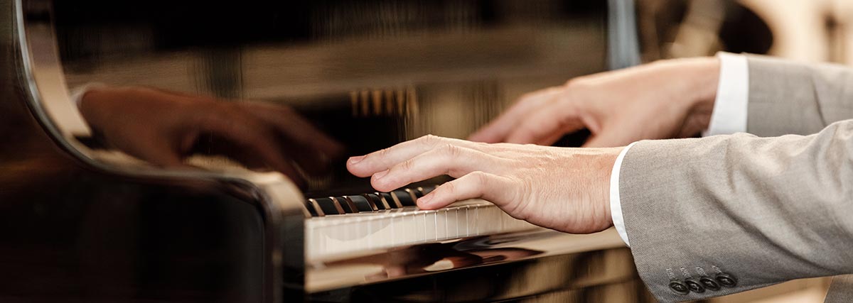pianist hands on grand piano keys