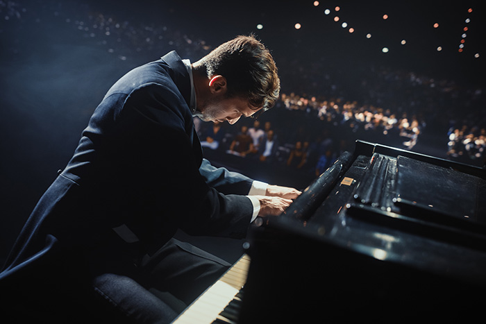Pianist performing on stage passionately