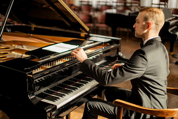 Professional musician gracefully play piano feat