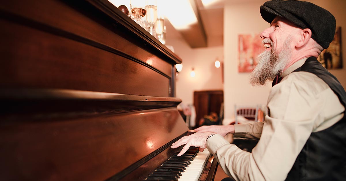 Smiling man playing piano