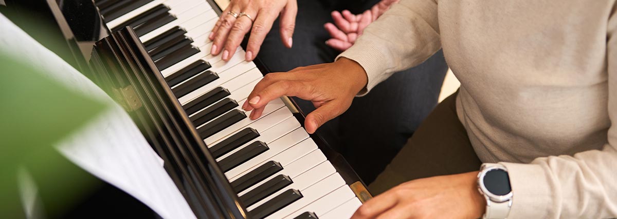 Teacher and student having piano lesson