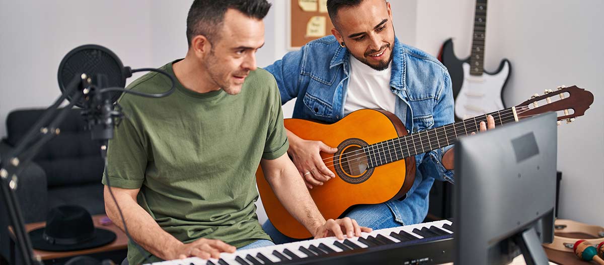 Two men playing guitar and piano