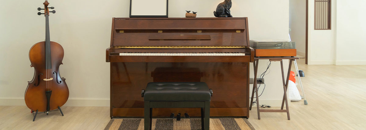 Upright piano and cello inside the room