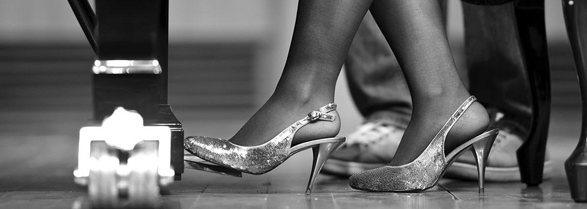 Woman foot stepping on piano pedal