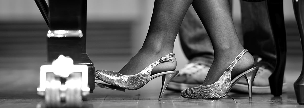 Woman foot stepping on the piano pedal