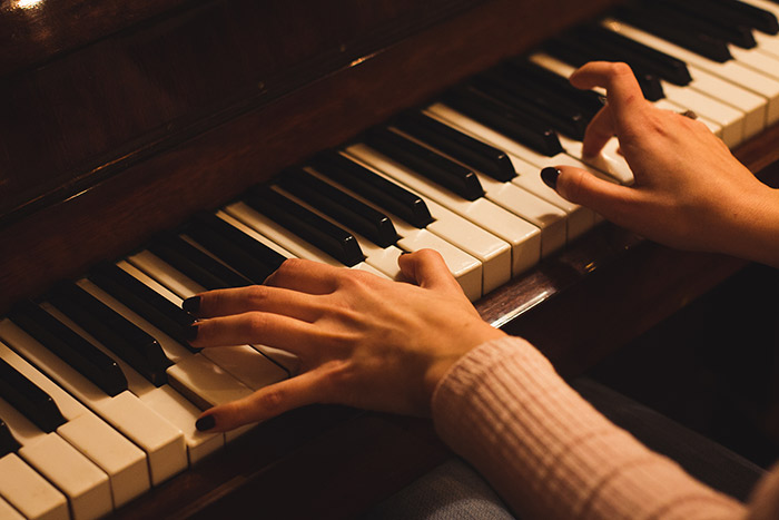 Woman hands playing piano