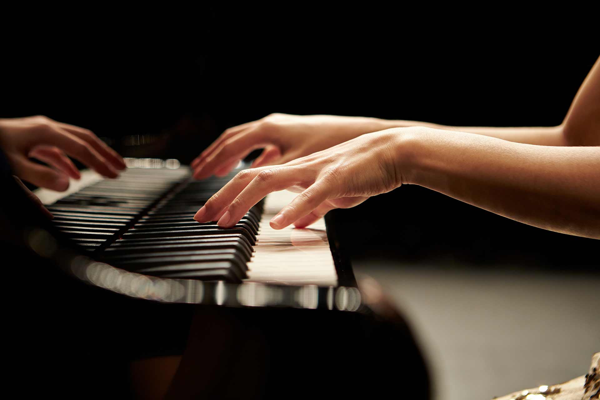 Woman hands playing piano