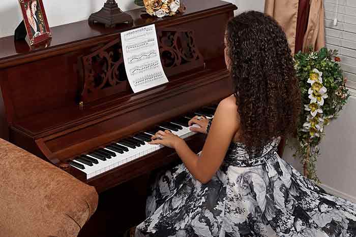 woman playing the piano at home feat