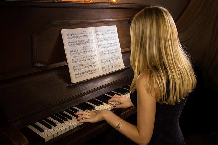 woman playing the piano feat
